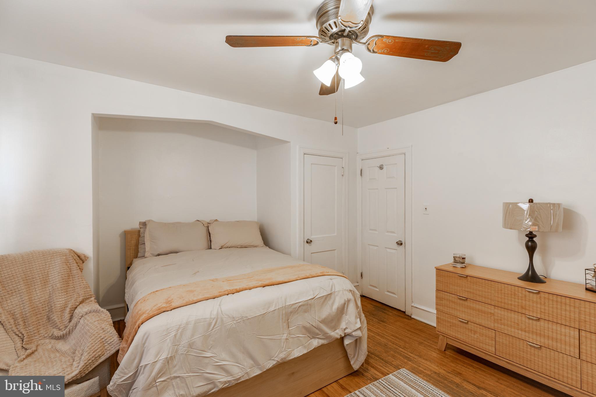 578 Rosalie Street, Unit A Philadelphia, PA 19120 - Photo 11 of 14 a bedroom with a bed and a chandelier