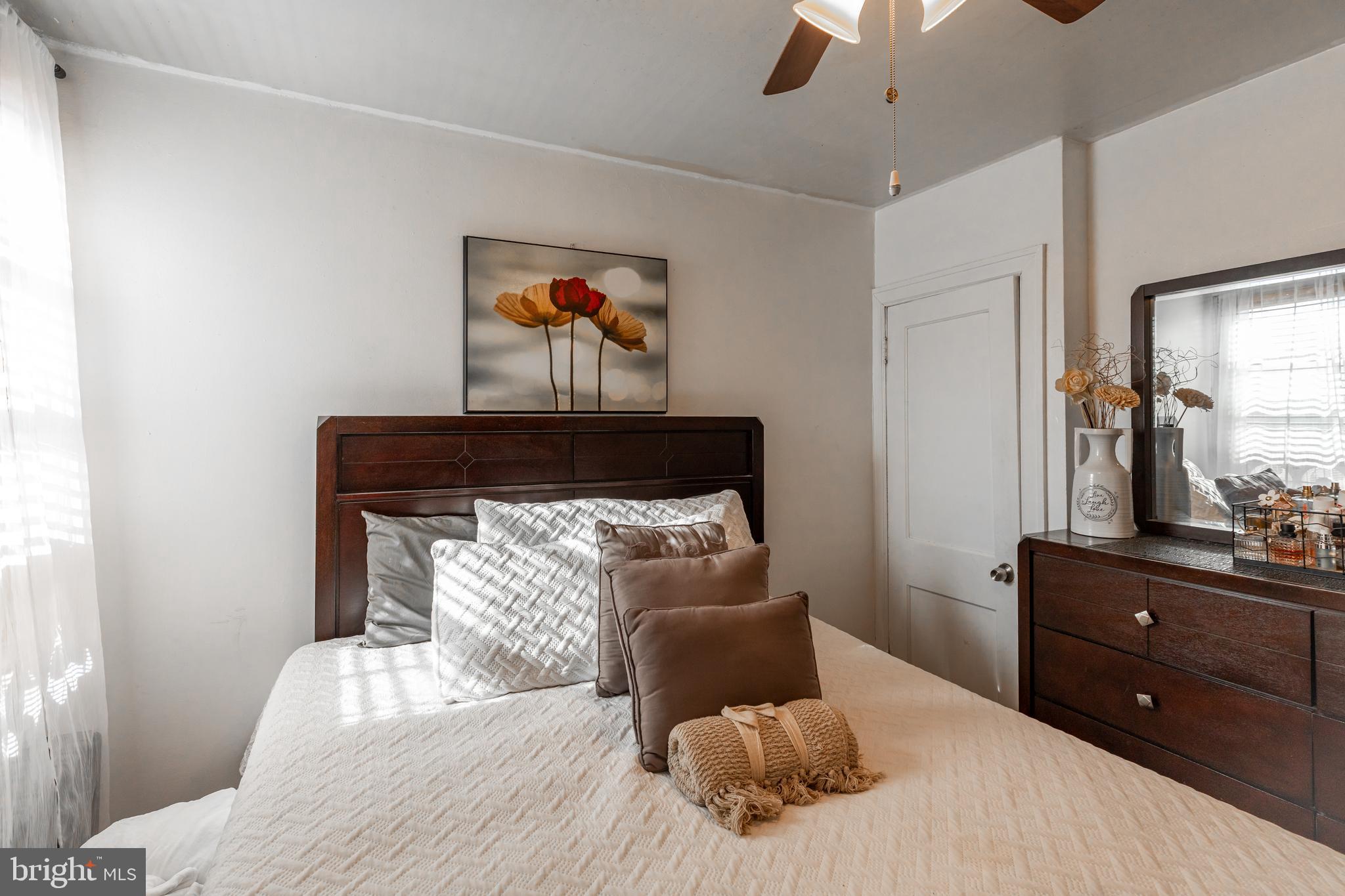 578 Rosalie Street, Unit A Philadelphia, PA 19120 - Photo 12 of 14 a bedroom with a bed and a chandelier