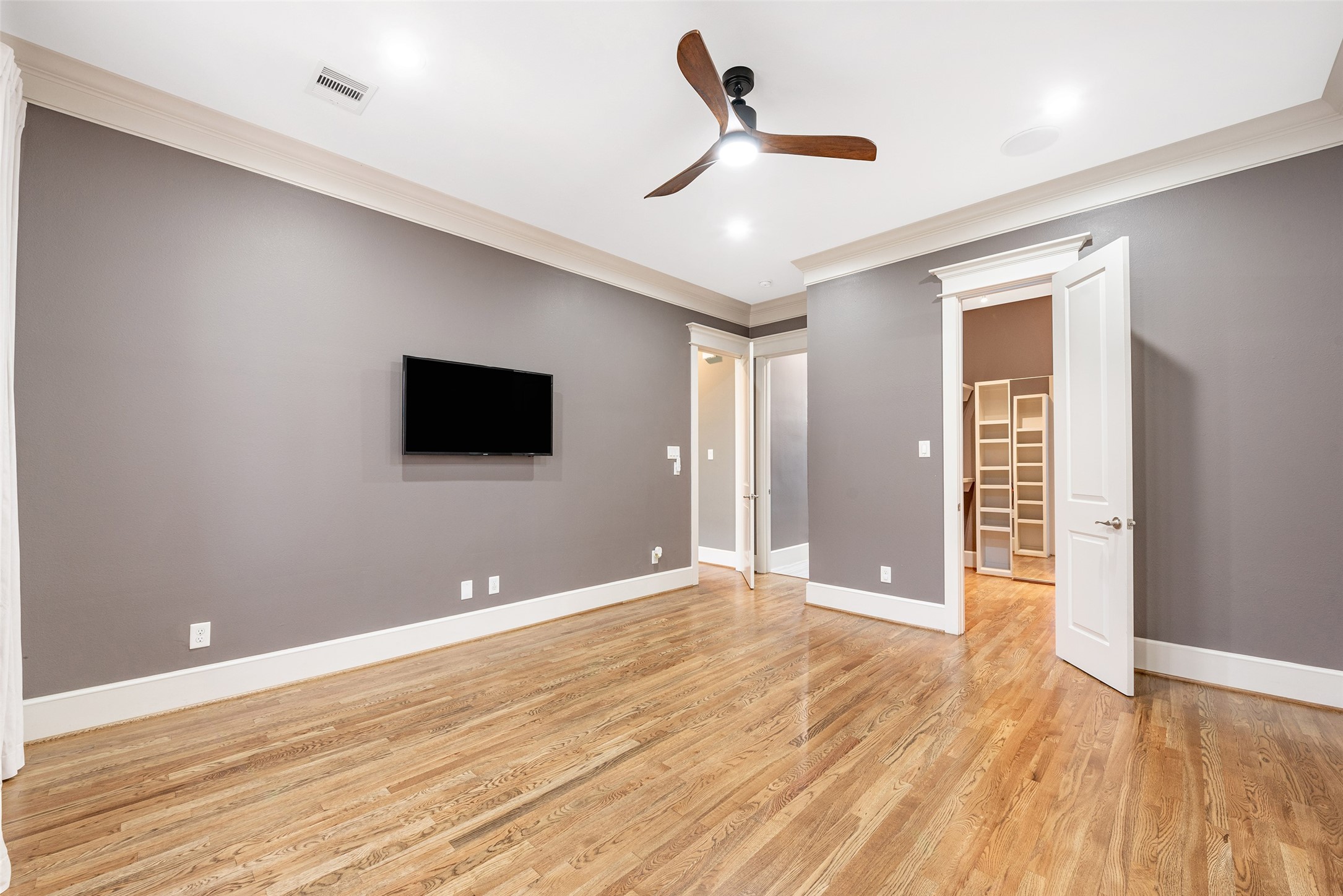 212 West 6th Street Houston, TX 77007 - Photo 13 of 45 a view of an empty room with wooden floor and a ceiling fan