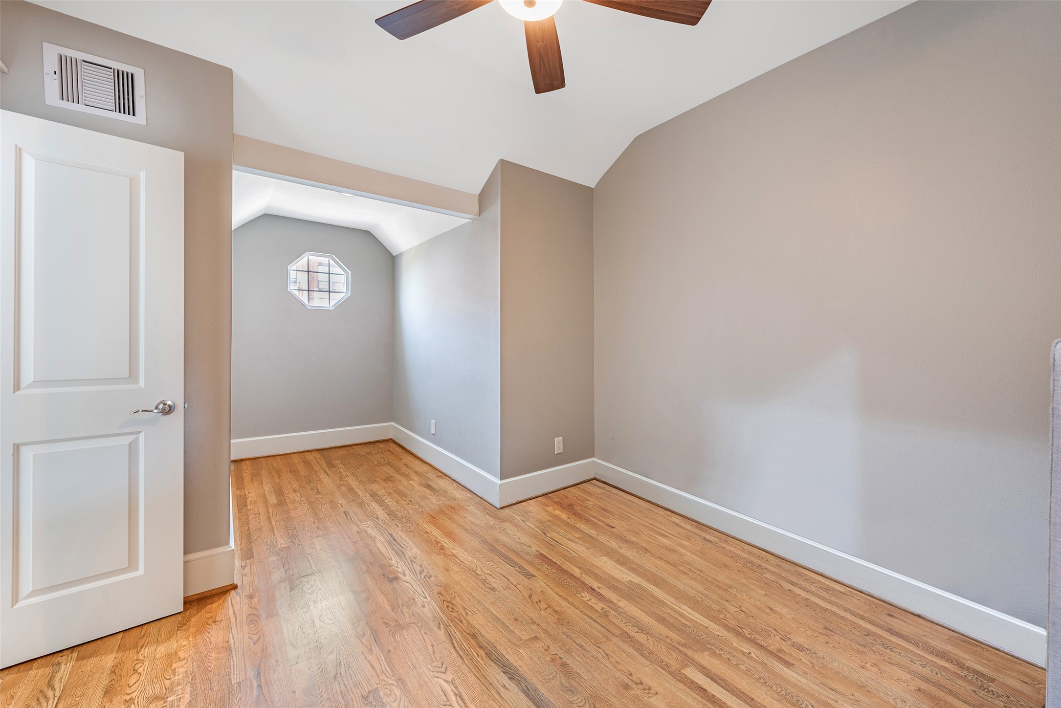 212 West 6th Street Houston, TX 77007 - Photo 36 of 45 a view of an empty room with wooden floor a ceiling fan