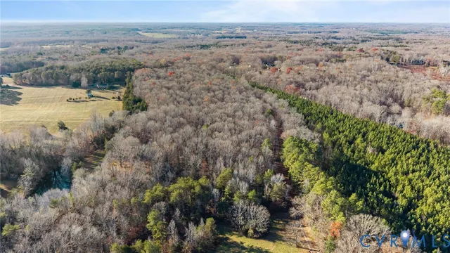 an aerial view of a houses with a yard