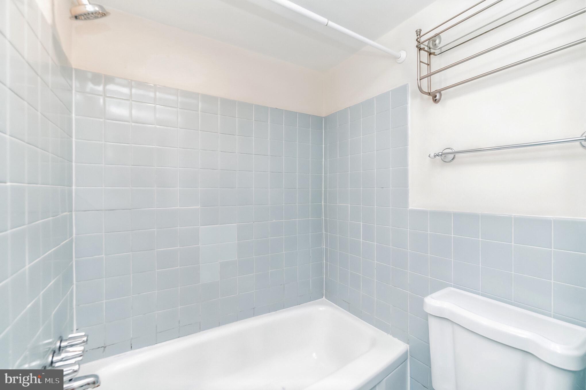 1420 N Street Northwest, Unit 605 Washington, DC 20005 - Photo 11 of 14 a bath tub sitting next to a white toilet