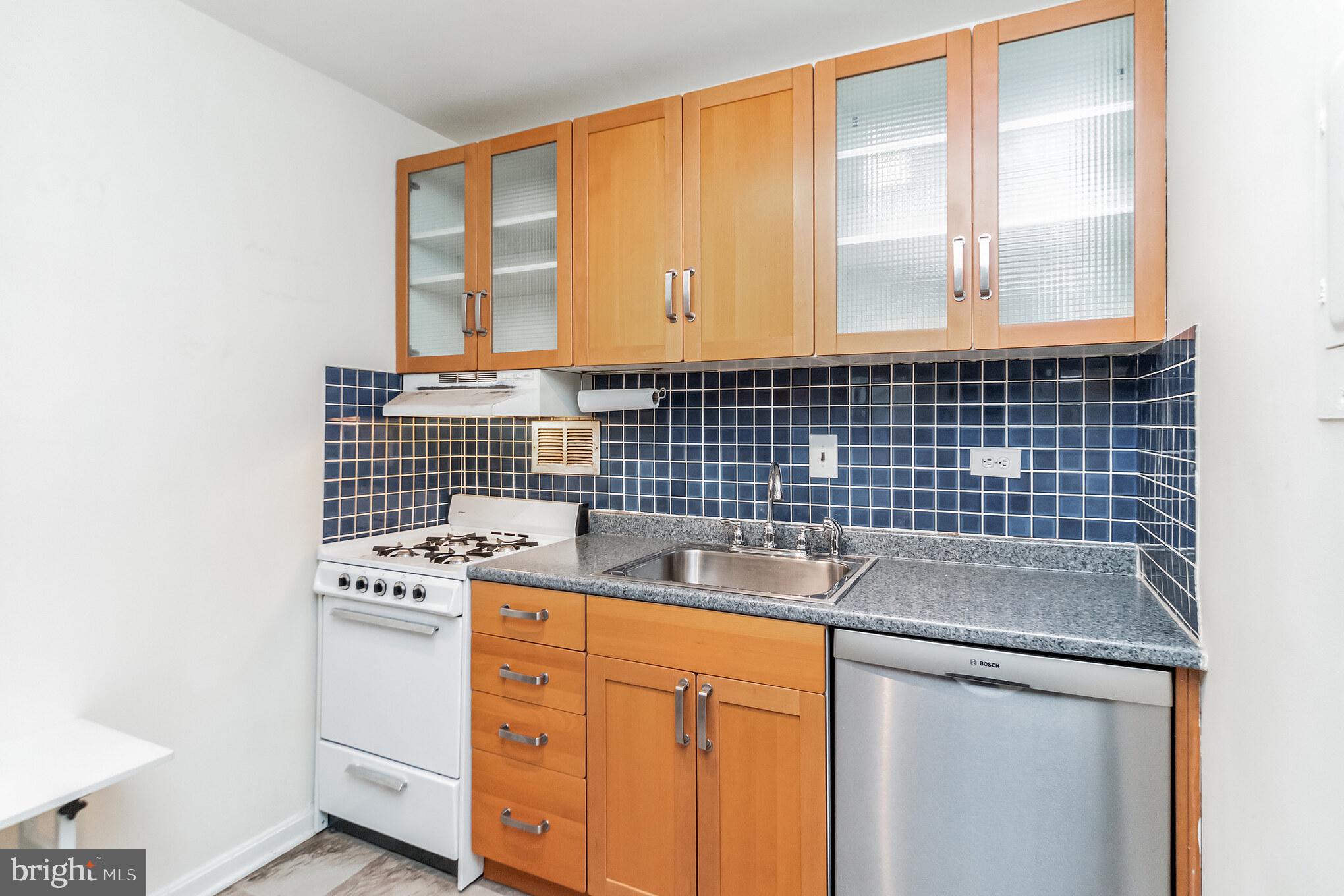 1420 N Street Northwest, Unit 605 Washington, DC 20005 - Photo 8 of 14 a bathroom with a sink and a washing machine
