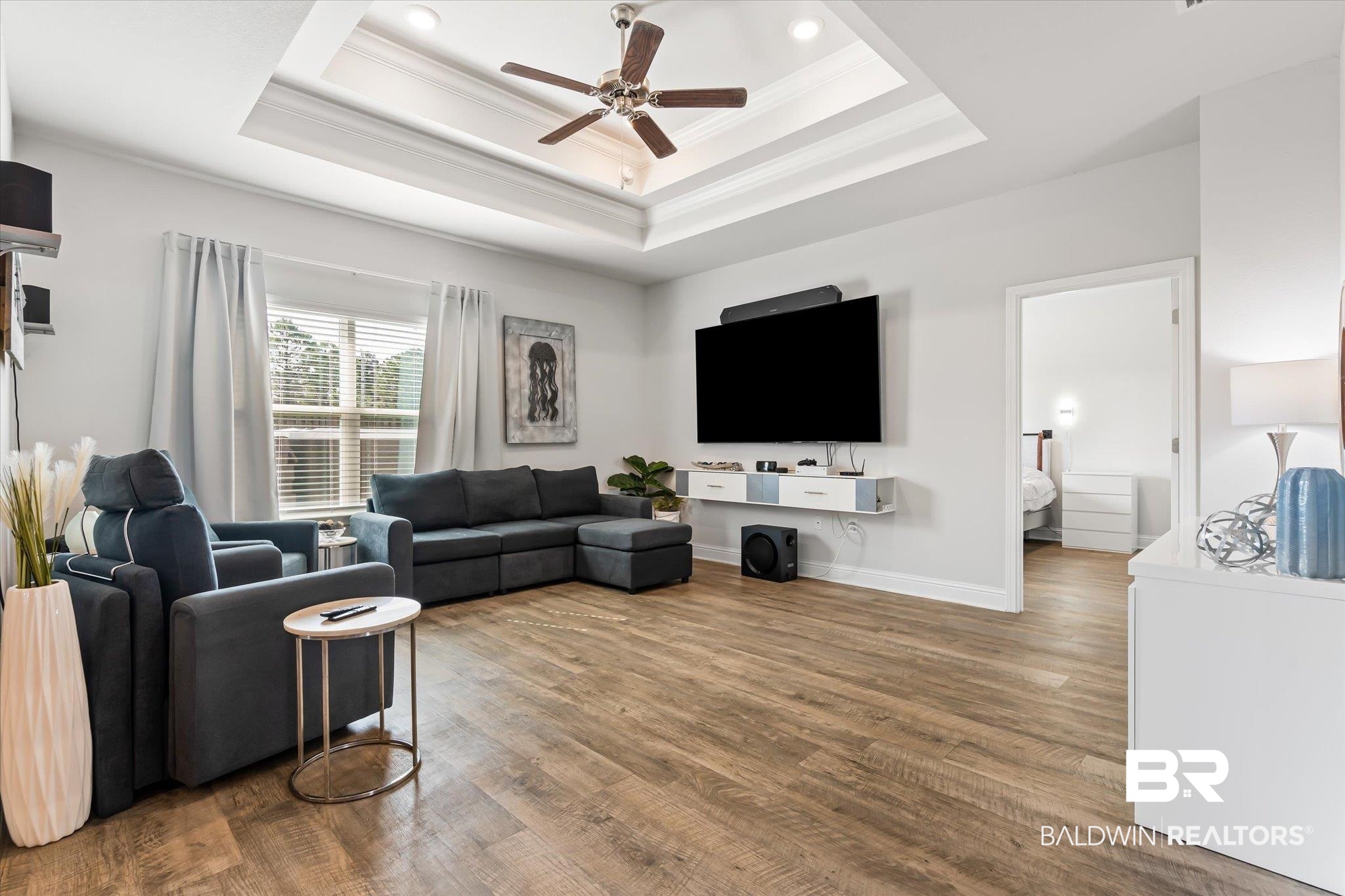 23246 Lieutenant Avenue Foley, AL 36535 - Photo 8 of 36 Living room featuring hardwood / wood-style flooring, crown molding, and a raised ceiling