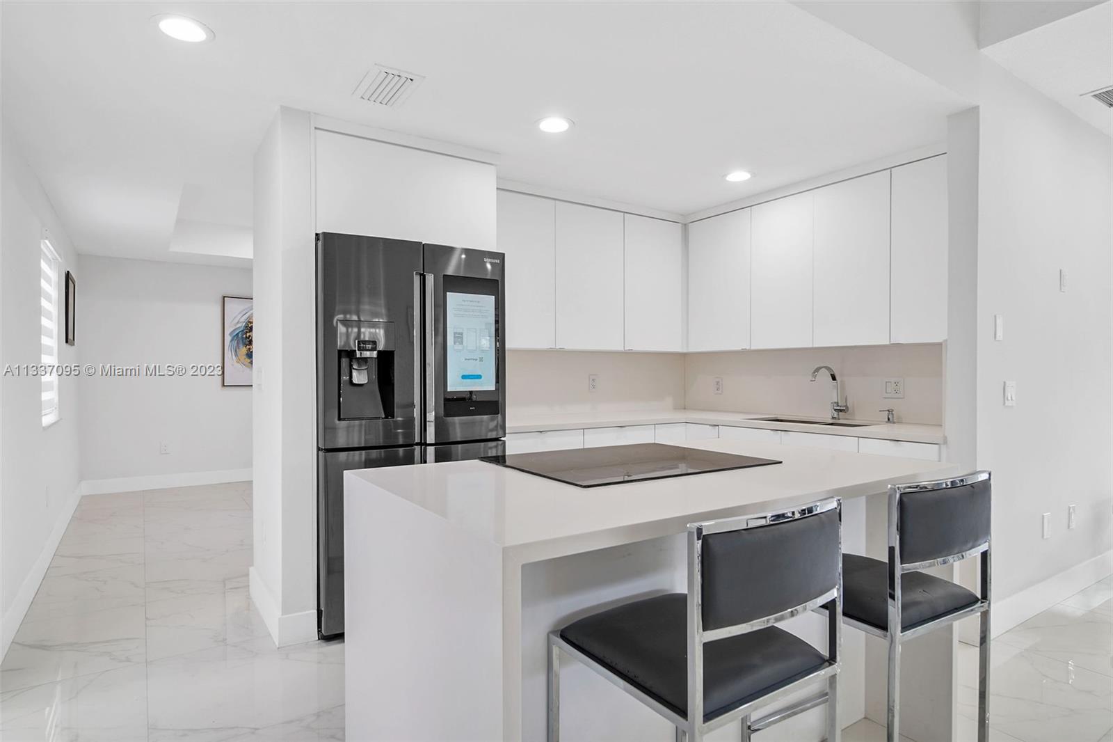 3436 Southwest 88th Place Miami, FL 33165 - Photo 11 of 43 a kitchen that has a table and chairs in it