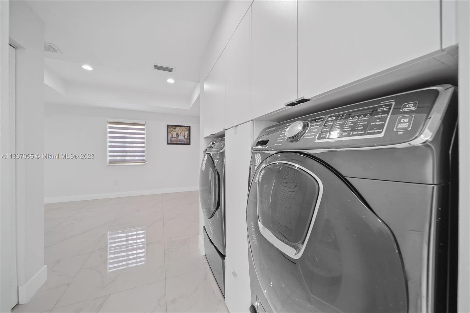 3436 Southwest 88th Place Miami, FL 33165 - Photo 15 of 43 a utility room with dryer and washer