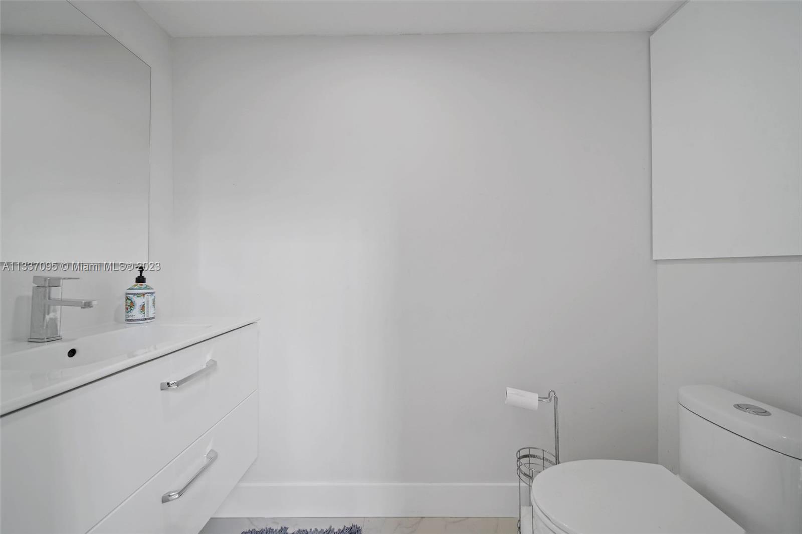 3436 Southwest 88th Place Miami, FL 33165 - Photo 27 of 43 a bathroom with a toilet a sink and mirror