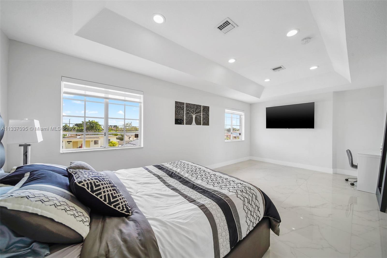 3436 Southwest 88th Place Miami, FL 33165 - Photo 30 of 43 a bedroom with a bed and a flat screen tv