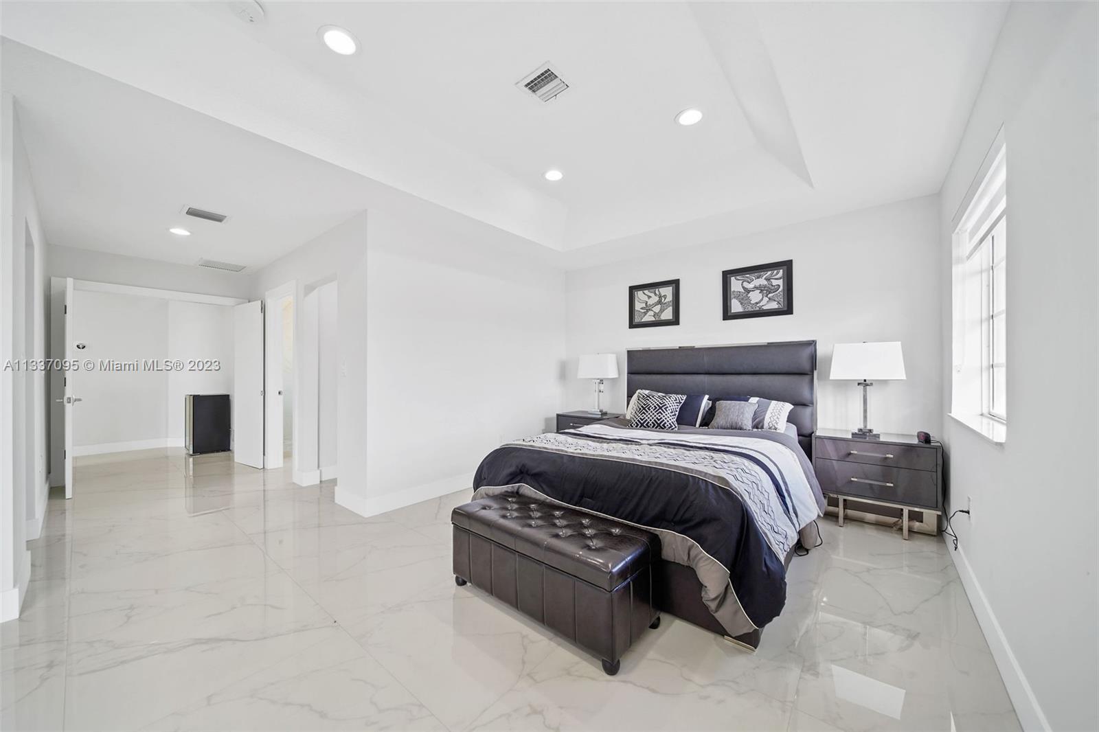 3436 Southwest 88th Place Miami, FL 33165 - Photo 31 of 43 a spacious bedroom with a bed and a couch