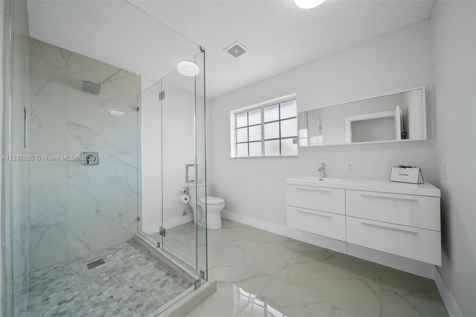3436 Southwest 88th Place Miami, FL 33165 - Photo 32 of 43 a bathroom with a sink a toilet and shower