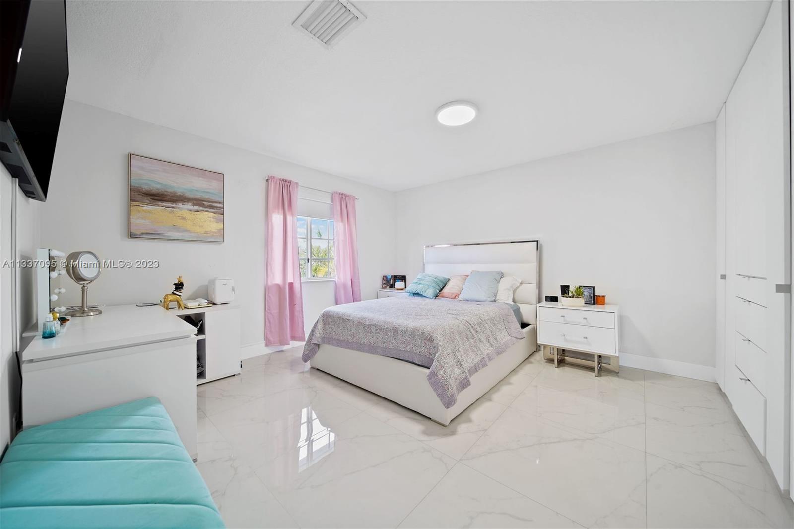 3436 Southwest 88th Place Miami, FL 33165 - Photo 35 of 43 a bedroom with a bed and a flat tv screen on the dresser