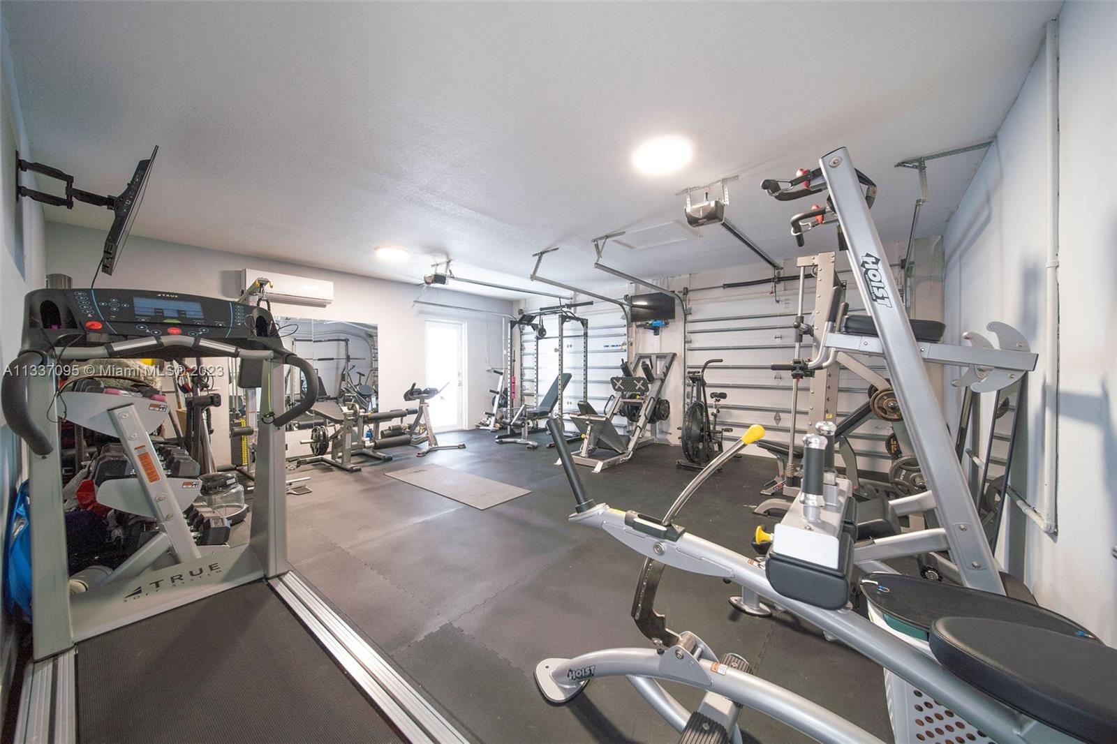 3436 Southwest 88th Place Miami, FL 33165 - Photo 40 of 43 a view of a room with gym equipment