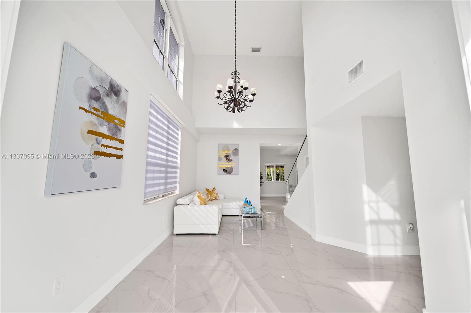 3436 Southwest 88th Place Miami, FL 33165 - Photo 4 of 43 a living room with furniture and a chandelier