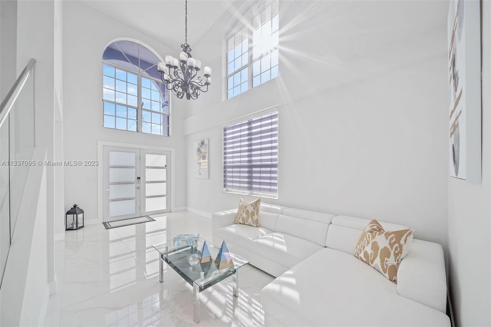 3436 Southwest 88th Place Miami, FL 33165 - Photo 5 of 43 a living room with furniture and a chandelier