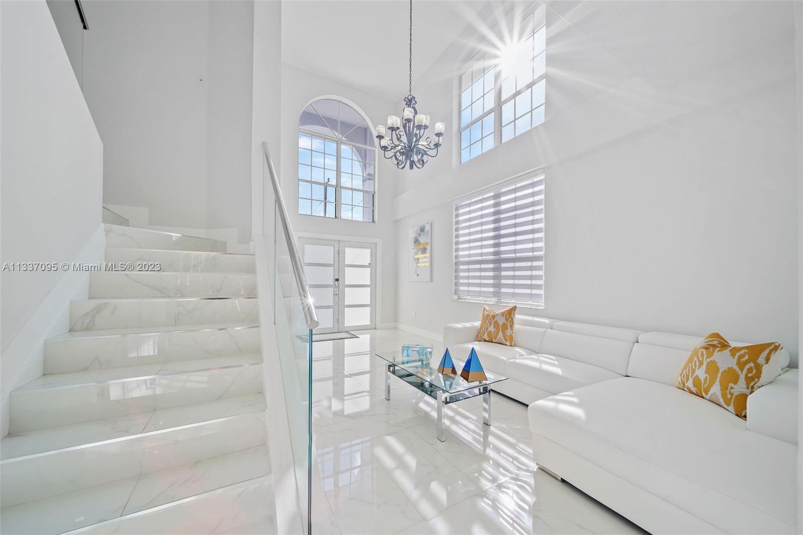 3436 Southwest 88th Place Miami, FL 33165 - Photo 6 of 43 a living room with furniture and a chandelier