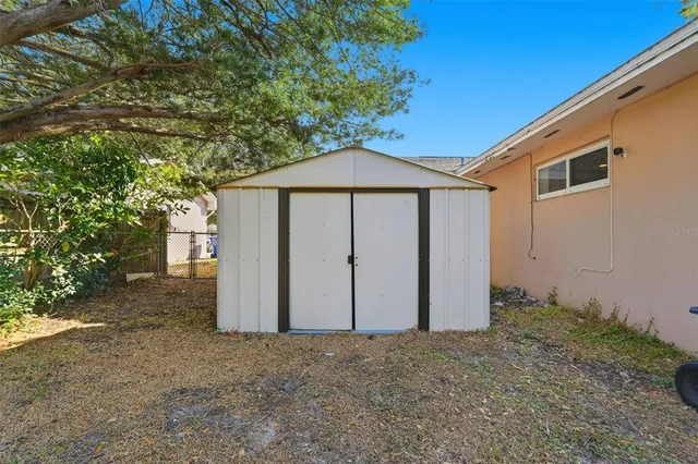 a wooden house with a tree in front of it