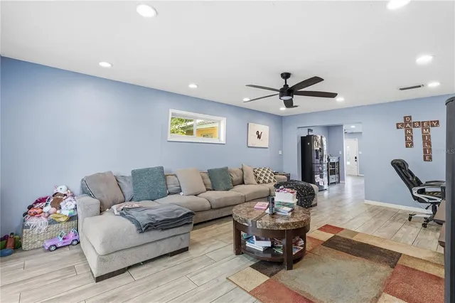 a living room with furniture and wooden floor