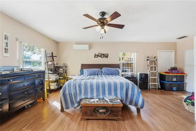 a bedroom with a bed and wooden floor