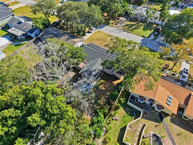 an aerial view of a house with a yard and garden