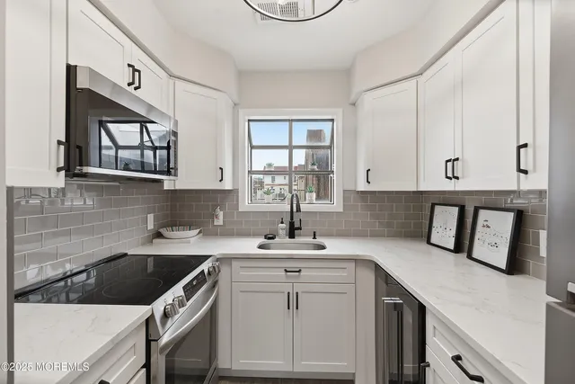 a kitchen with a sink cabinets and window
