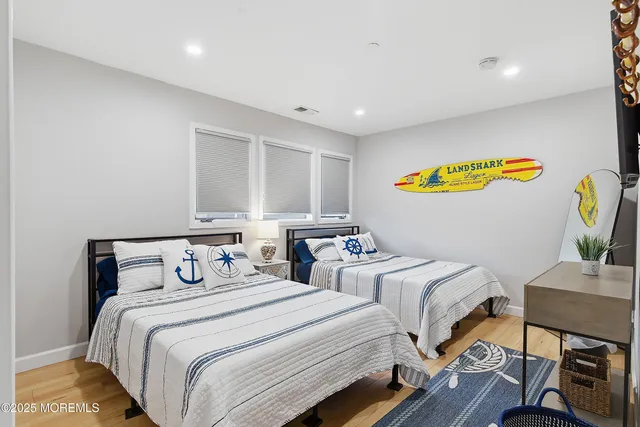 a bedroom with two beds and painting on the wall