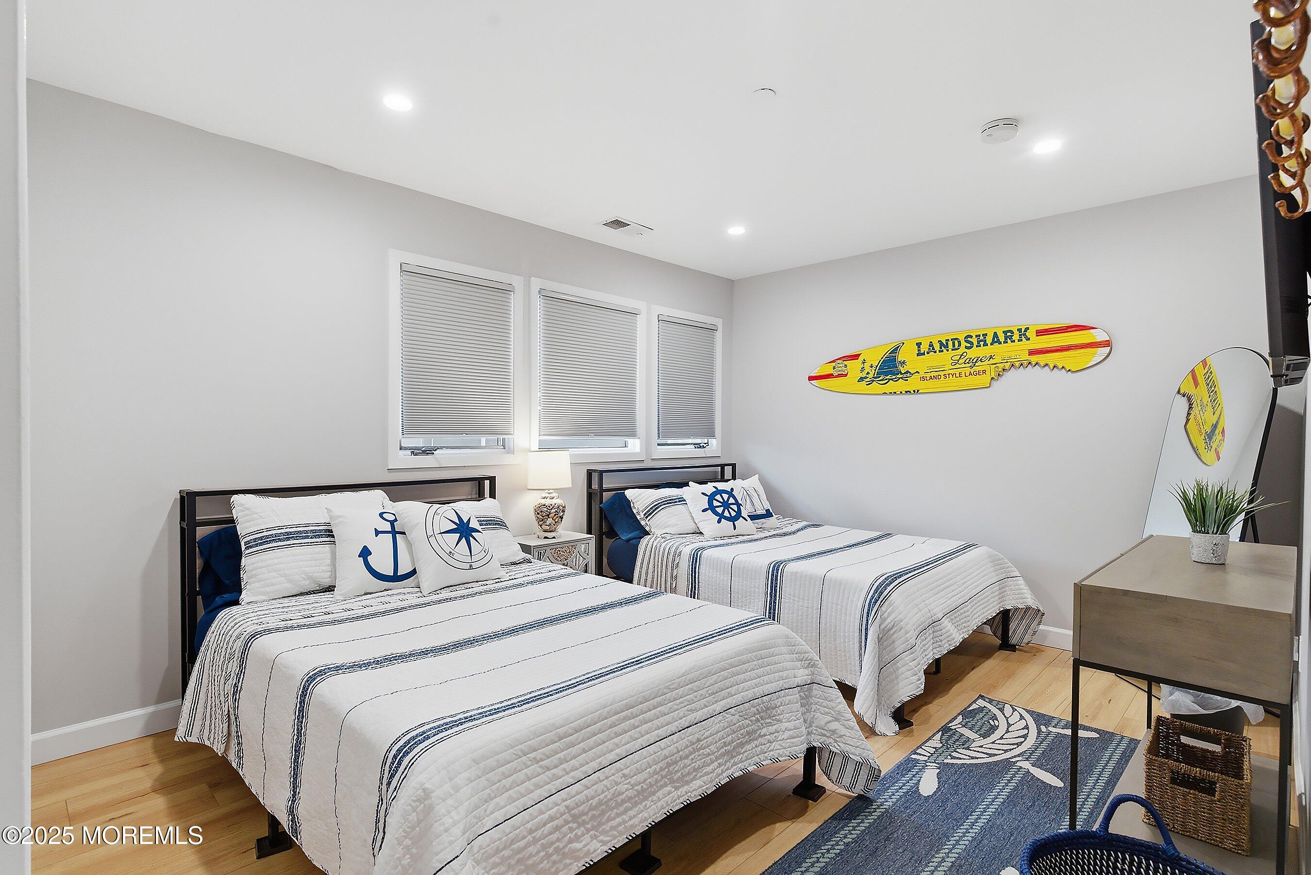 132 Sampson Avenue, Unit 2 Seaside Heights, NJ 08751 - Photo 13 of 41 a bedroom with two beds and painting on the wall