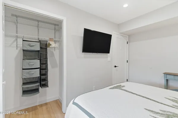 a bedroom with a bed and a flat screen tv