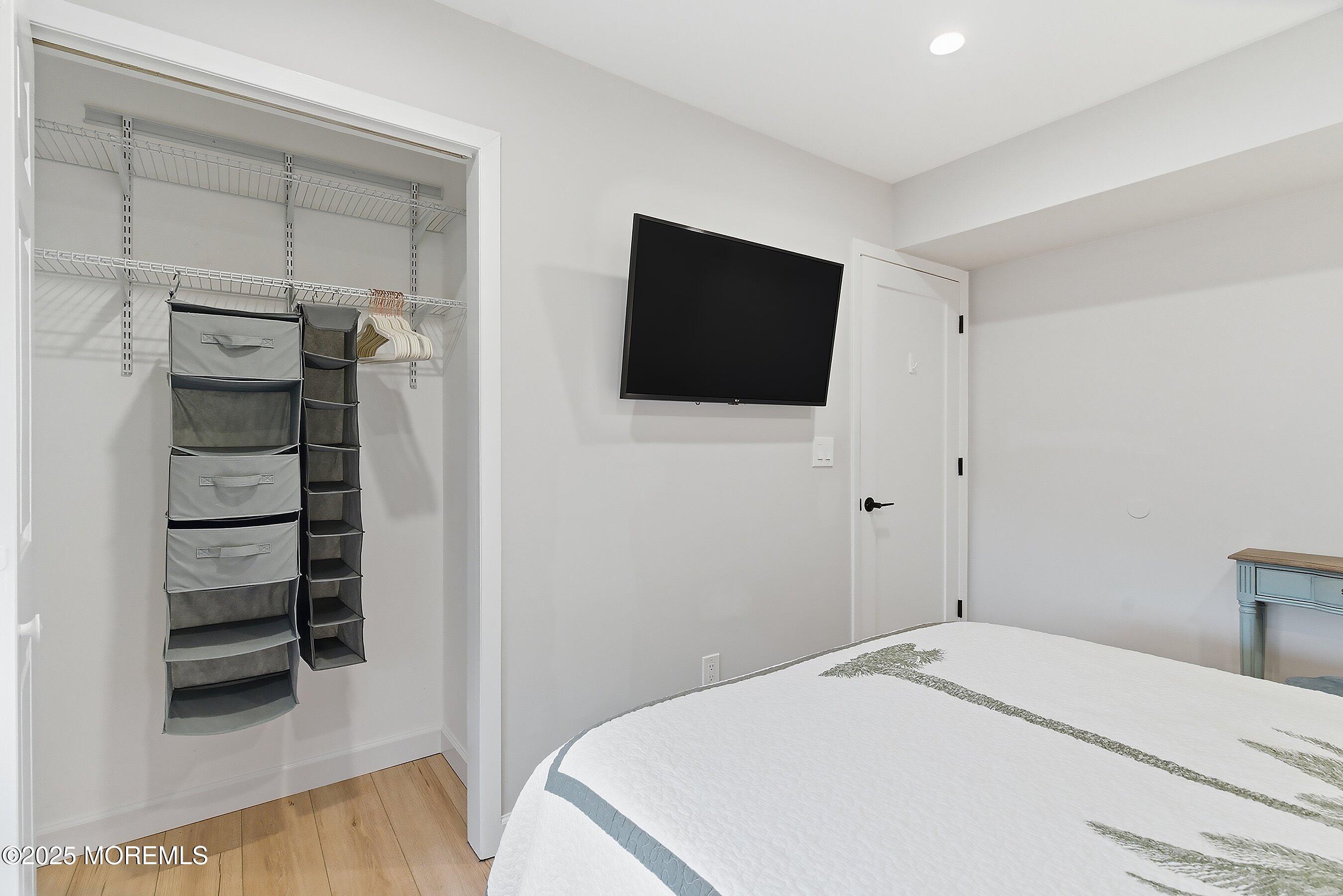 132 Sampson Avenue, Unit 2 Seaside Heights, NJ 08751 - Photo 14 of 41 a bedroom with a bed and a flat screen tv