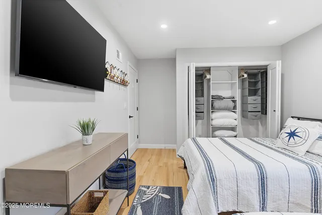 a bedroom with a bed and flat screen tv