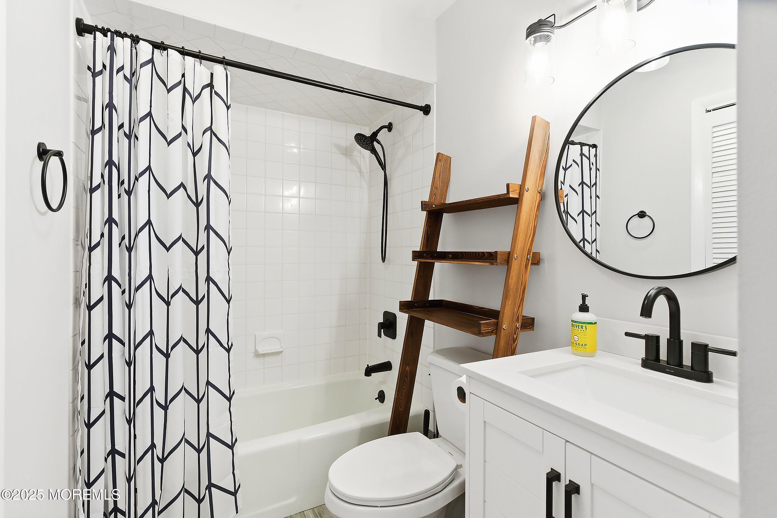 132 Sampson Avenue, Unit 2 Seaside Heights, NJ 08751 - Photo 17 of 41 a bathroom with a sink a toilet and a mirror