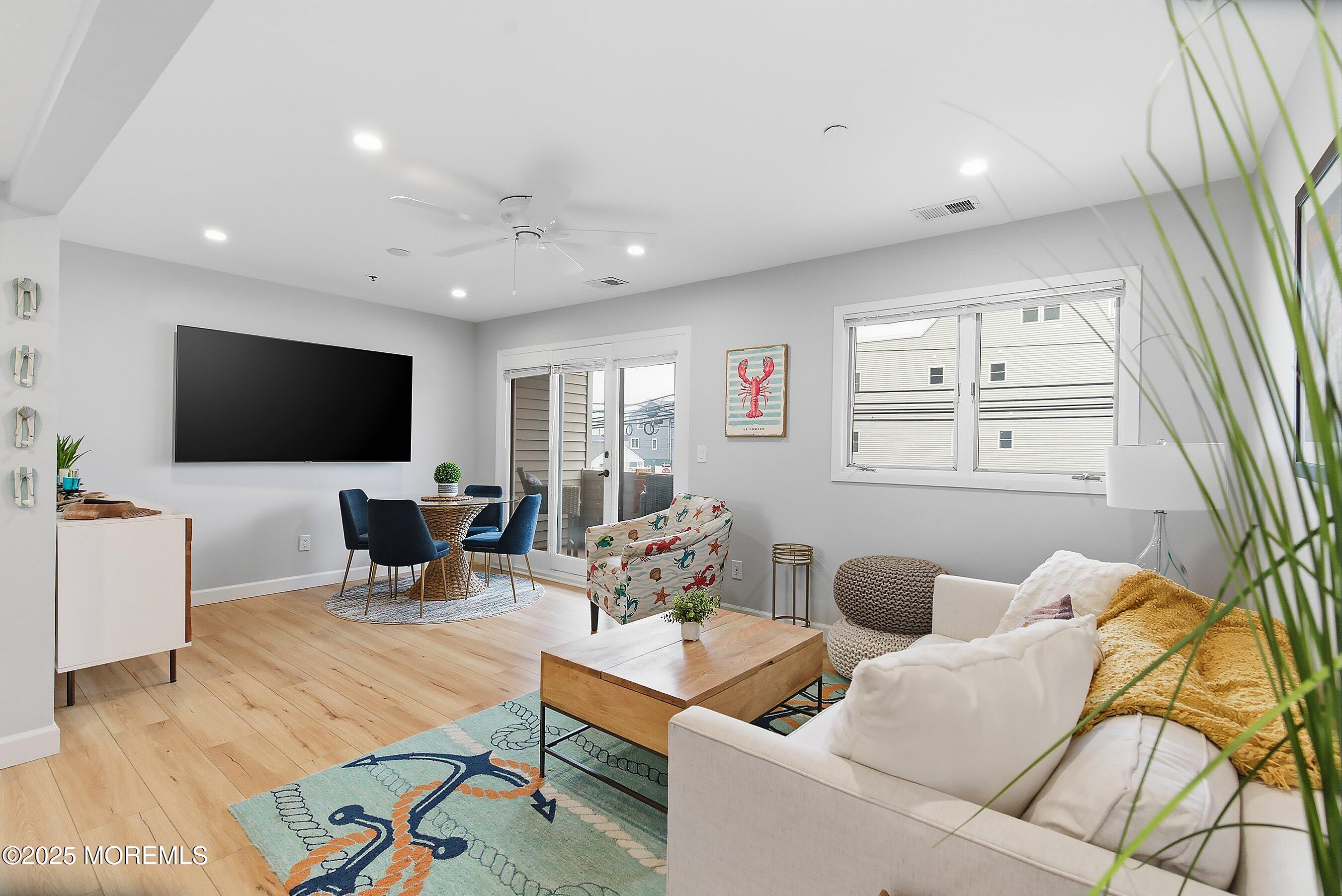 132 Sampson Avenue, Unit 2 Seaside Heights, NJ 08751 - Photo 2 of 41 a living room with furniture and a flat screen tv