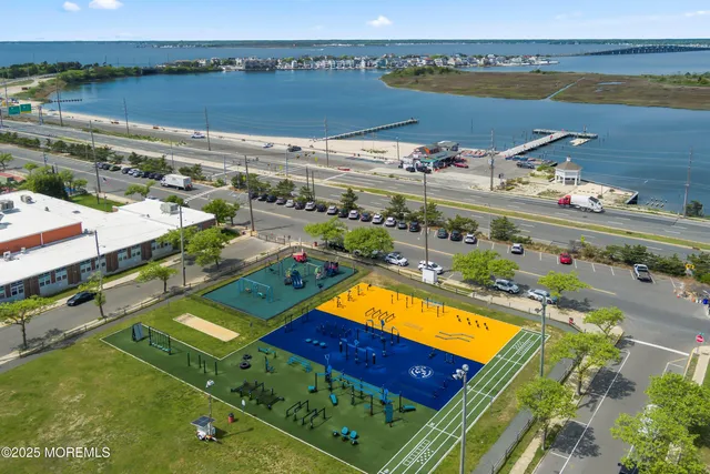 an aerial view of a resort with a swimming pool and outdoor seating