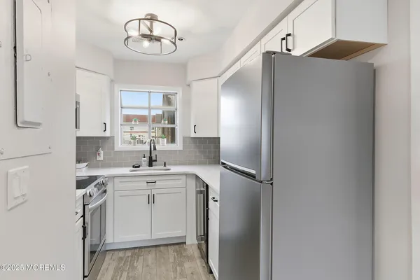 a kitchen with a sink and a refrigerator