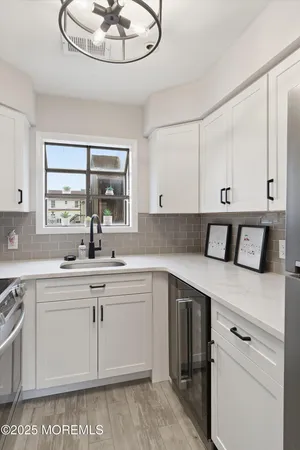 a kitchen with appliances cabinets and a sink