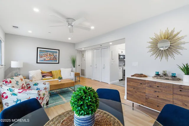 a living room with furniture and a chandelier