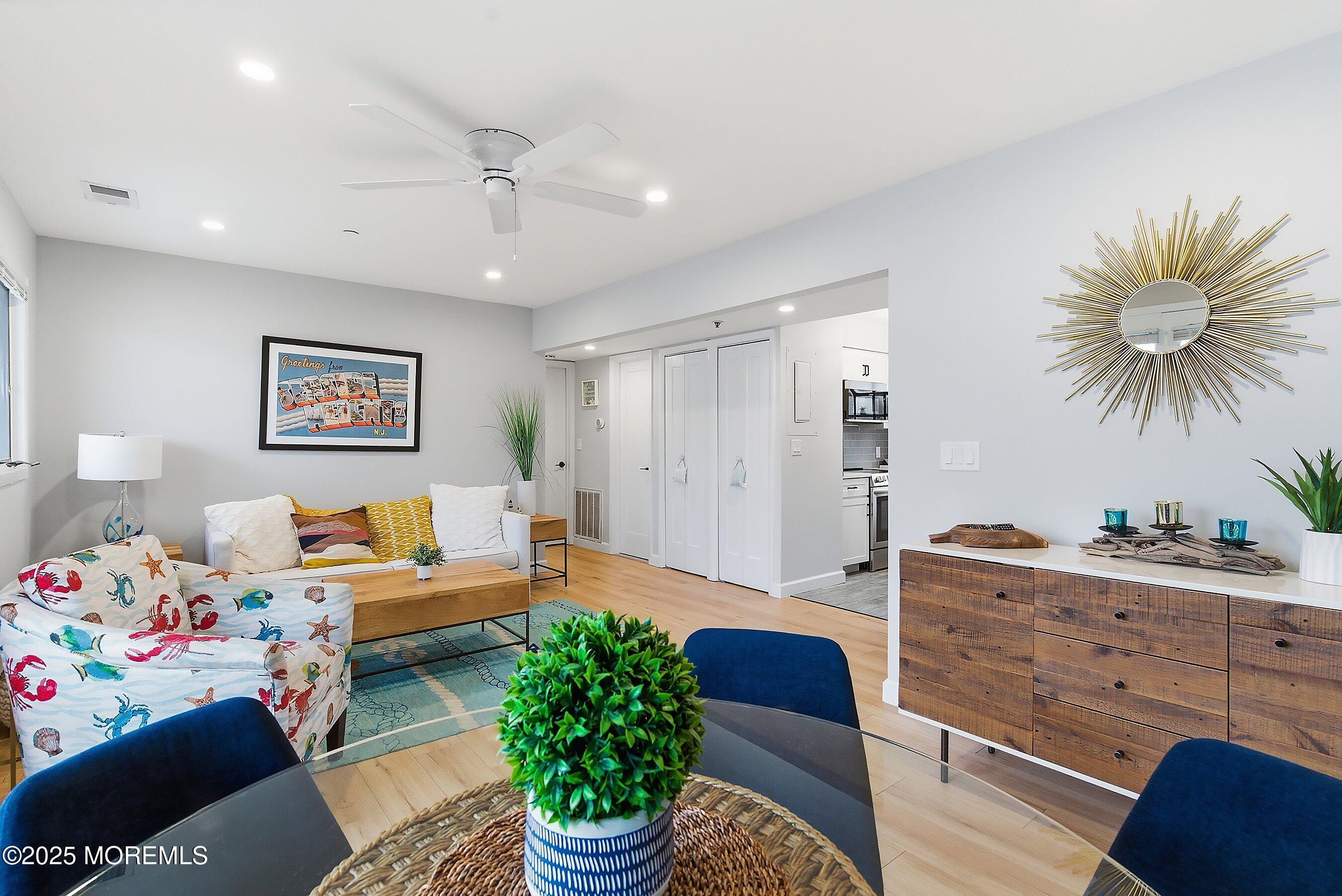 132 Sampson Avenue, Unit 2 Seaside Heights, NJ 08751 - Photo 9 of 41 a living room with furniture and a chandelier