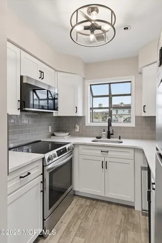 a kitchen with a stove cabinets and window