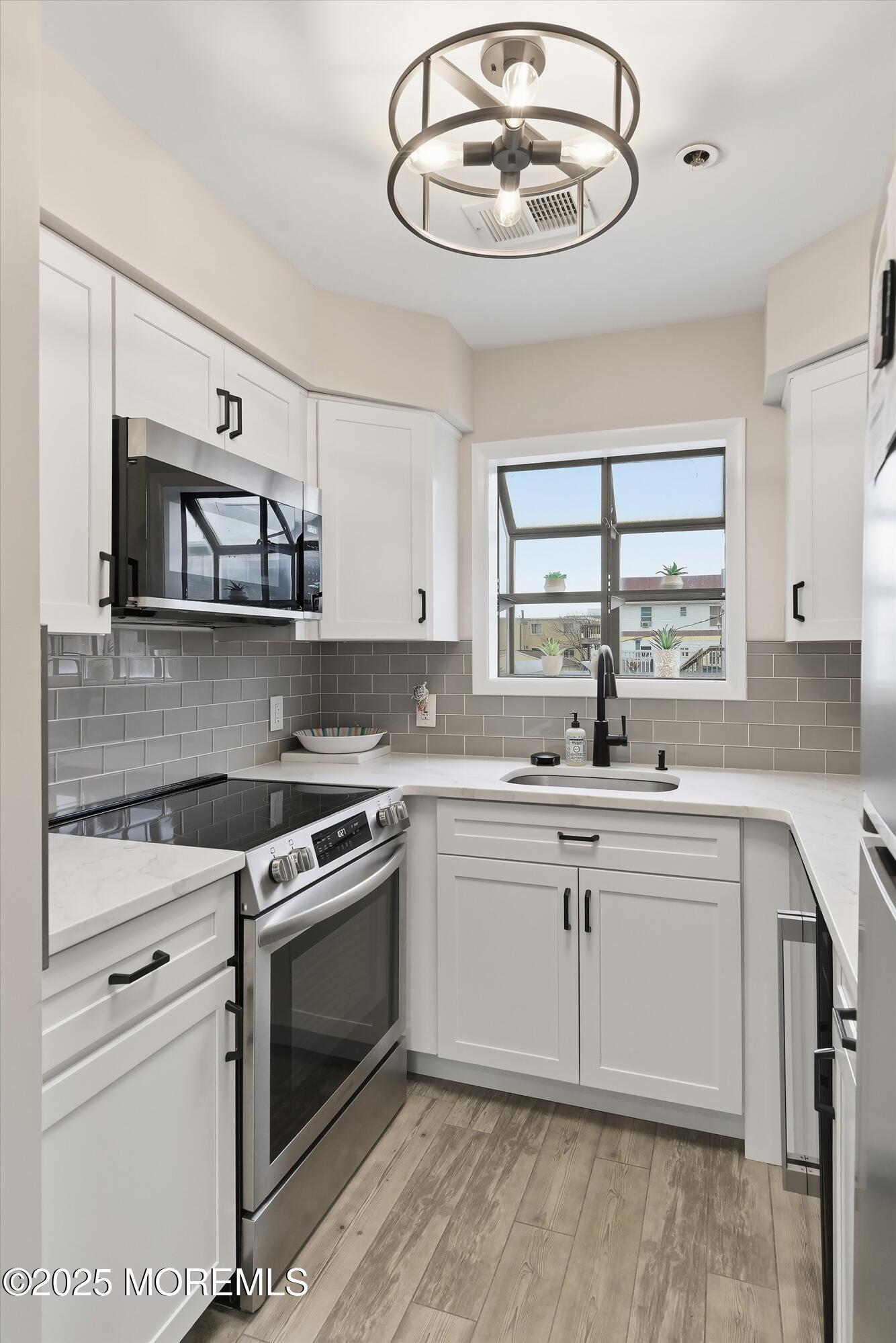 132 Sampson Avenue, Unit 2 Seaside Heights, NJ 08751 - Photo 10 of 41 a kitchen with a stove cabinets and window