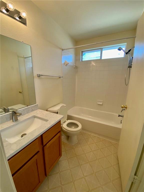 512 Celery Loop Austin, TX 78748 - Photo 14 of 26 a bathroom with a granite countertop sink a toilet a mirror and shower