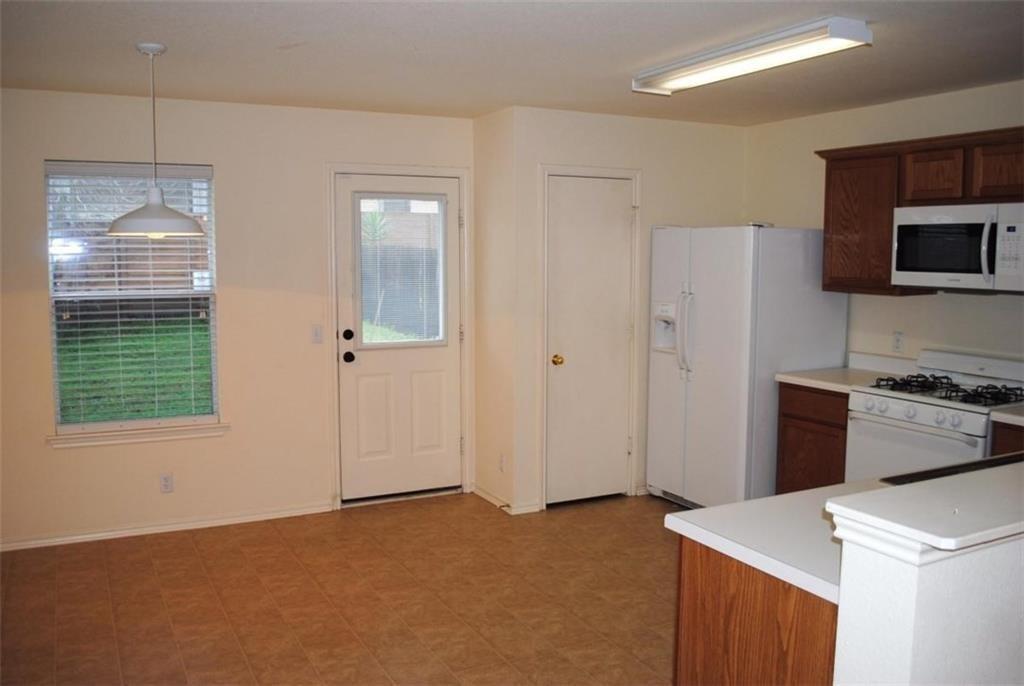 512 Celery Loop Austin, TX 78748 - Photo 15 of 26 a kitchen with a refrigerator stove and cabinets