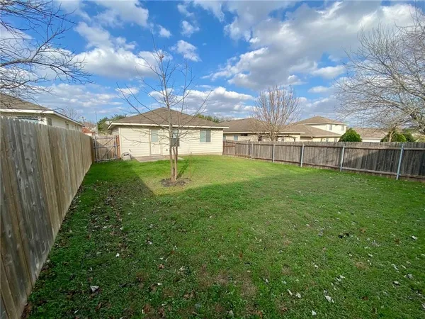 a view of a backyard with large trees