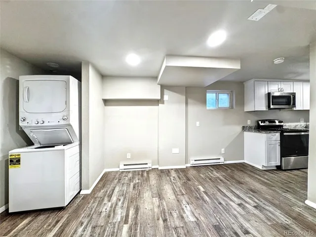 a kitchen with a refrigerator and a stove top oven