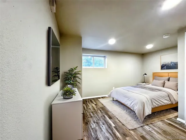 a bedroom with a bed and a potted plant