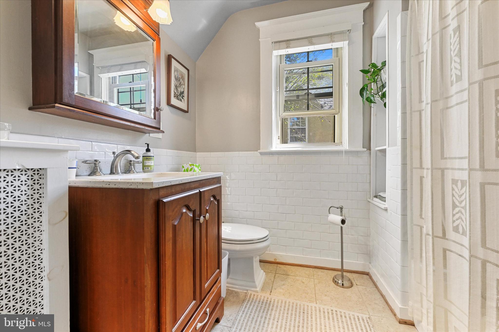 306 St Dunstans Road Baltimore, MD 21212 - Photo 25 of 56 a bathroom with a sink a toilet and a mirror