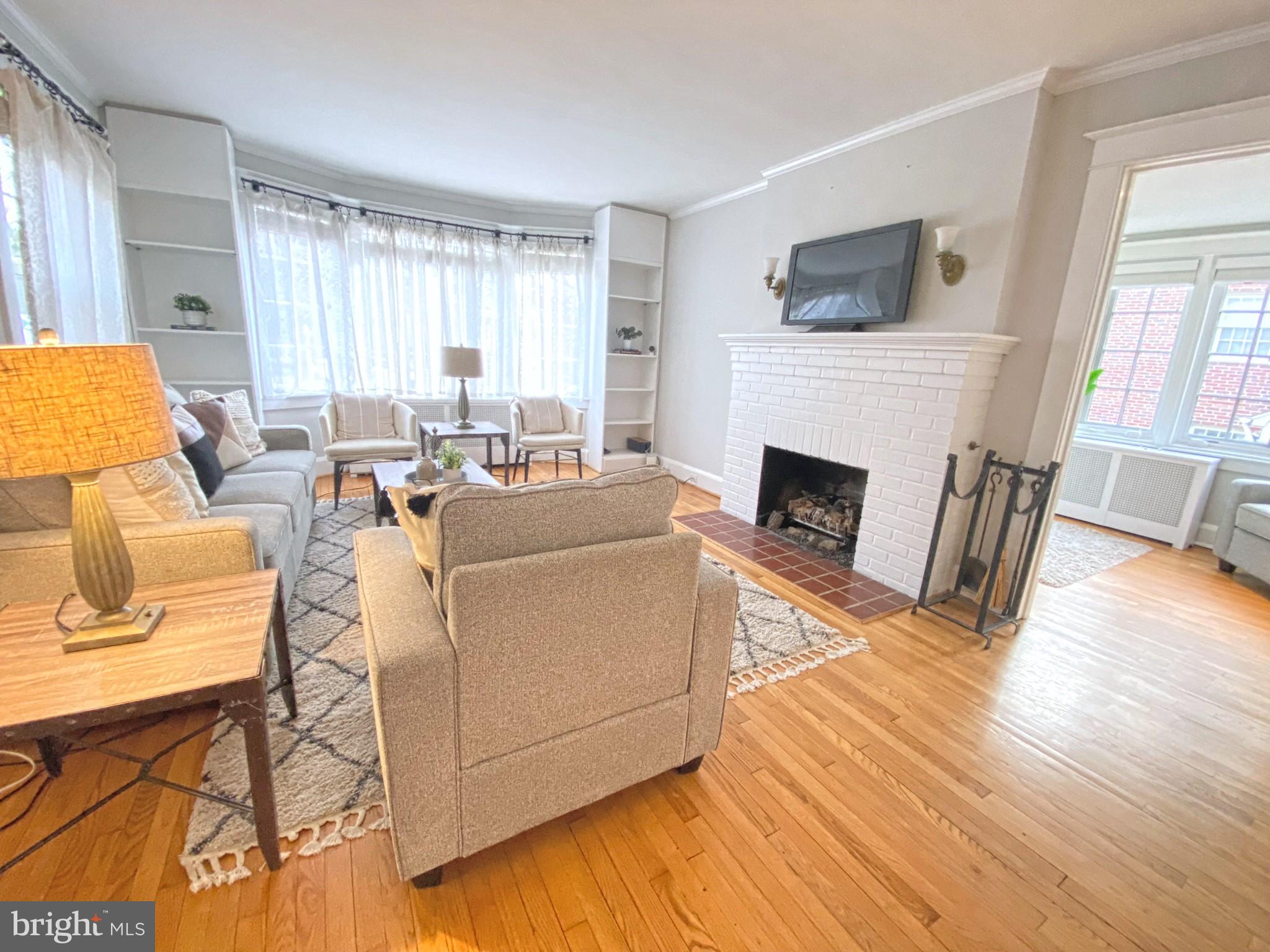 306 St Dunstans Road Baltimore, MD 21212 - Photo 7 of 56 a living room with furniture a fireplace and a flat screen tv