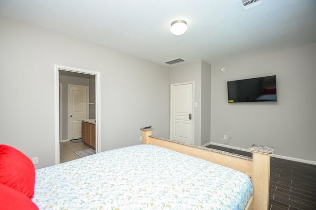 3318 Grand Cane Lane Rosenberg, TX 77471 - Photo 12 of 19 a bedroom with a bed and a flat screen tv