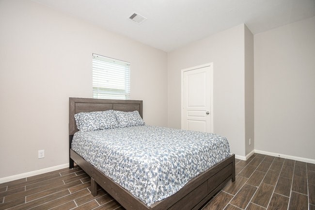 3318 Grand Cane Lane Rosenberg, TX 77471 - Photo 2 of 19 a bedroom with a bed and window