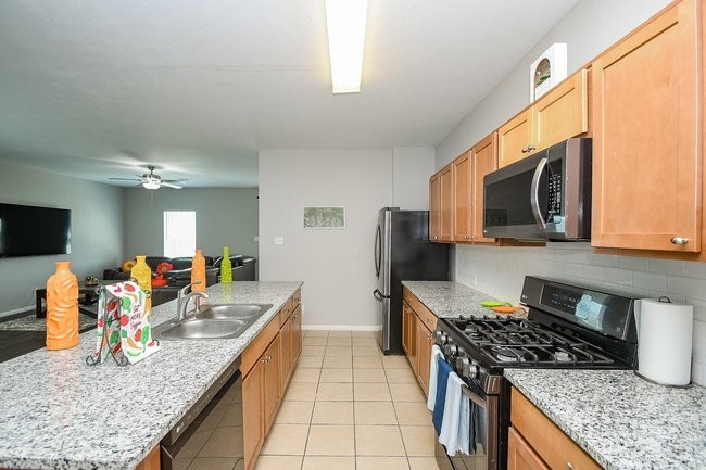 3318 Grand Cane Lane Rosenberg, TX 77471 - Photo 6 of 19 a kitchen with stainless steel appliances granite countertop a sink stove and refrigerator