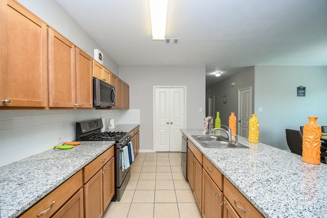 3318 Grand Cane Lane Rosenberg, TX 77471 - Photo 8 of 19 a kitchen with stainless steel appliances granite countertop a sink stove and cabinets