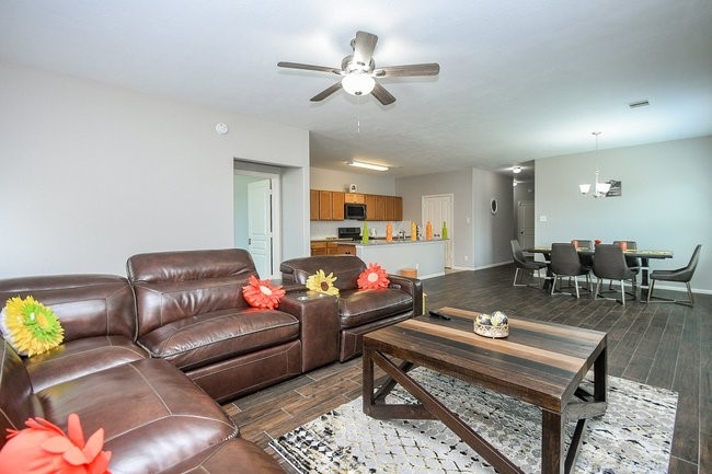 3318 Grand Cane Lane Rosenberg, TX 77471 - Photo 10 of 19 a living room with furniture a rug and a chandelier